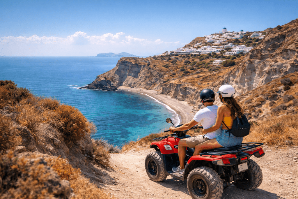 A couple riding a red ATV along a scenic coastal trail in Santorini, overlooking turquoise waters and white Cycladic buildings in the distance.